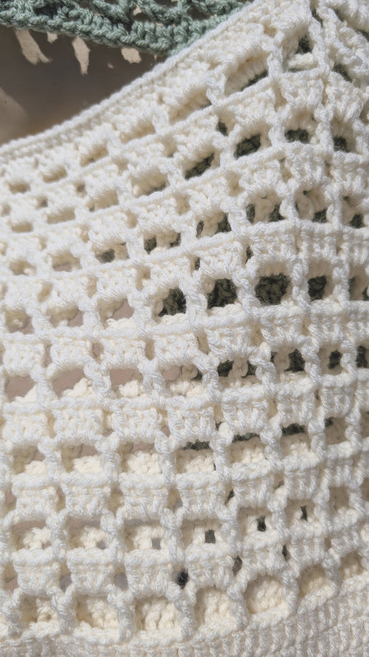 Close-up of a crocheted fabric with a textured pattern