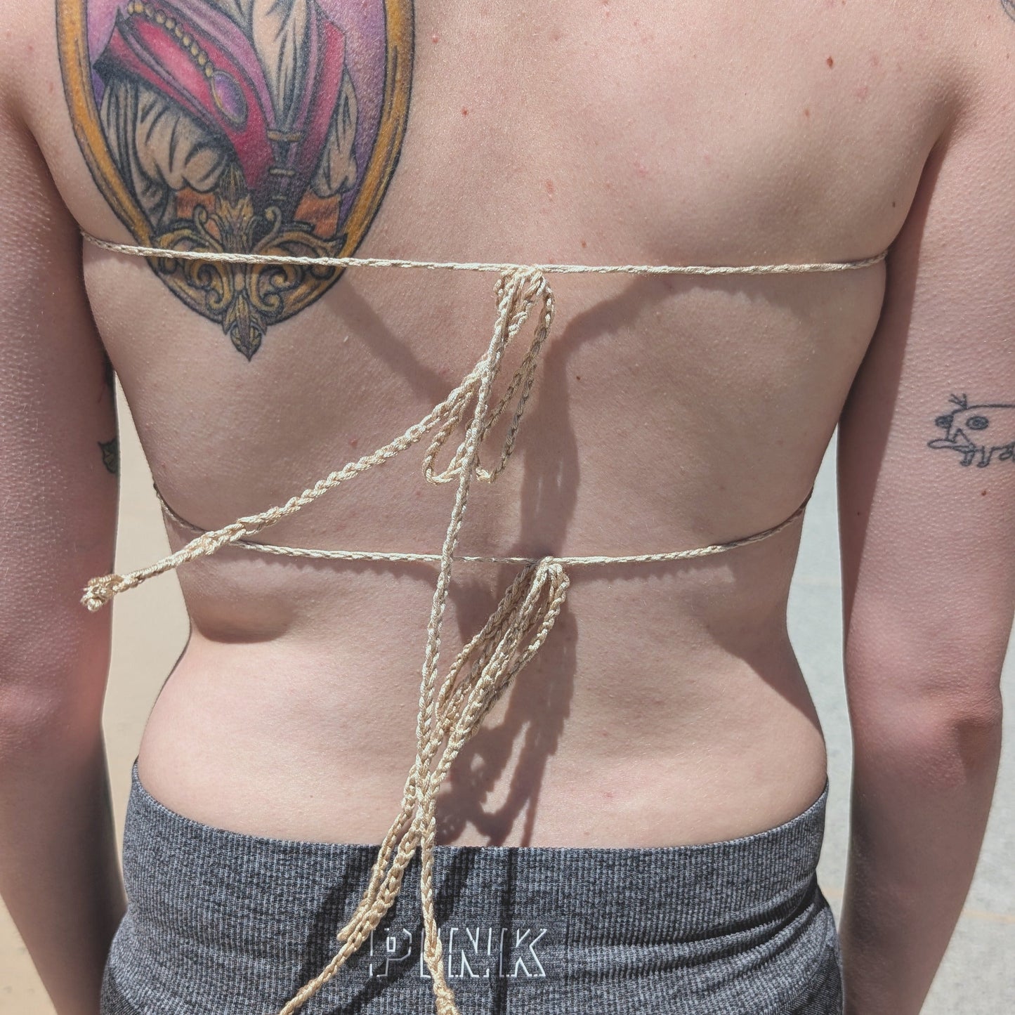 Ties in the back of the cream bralette