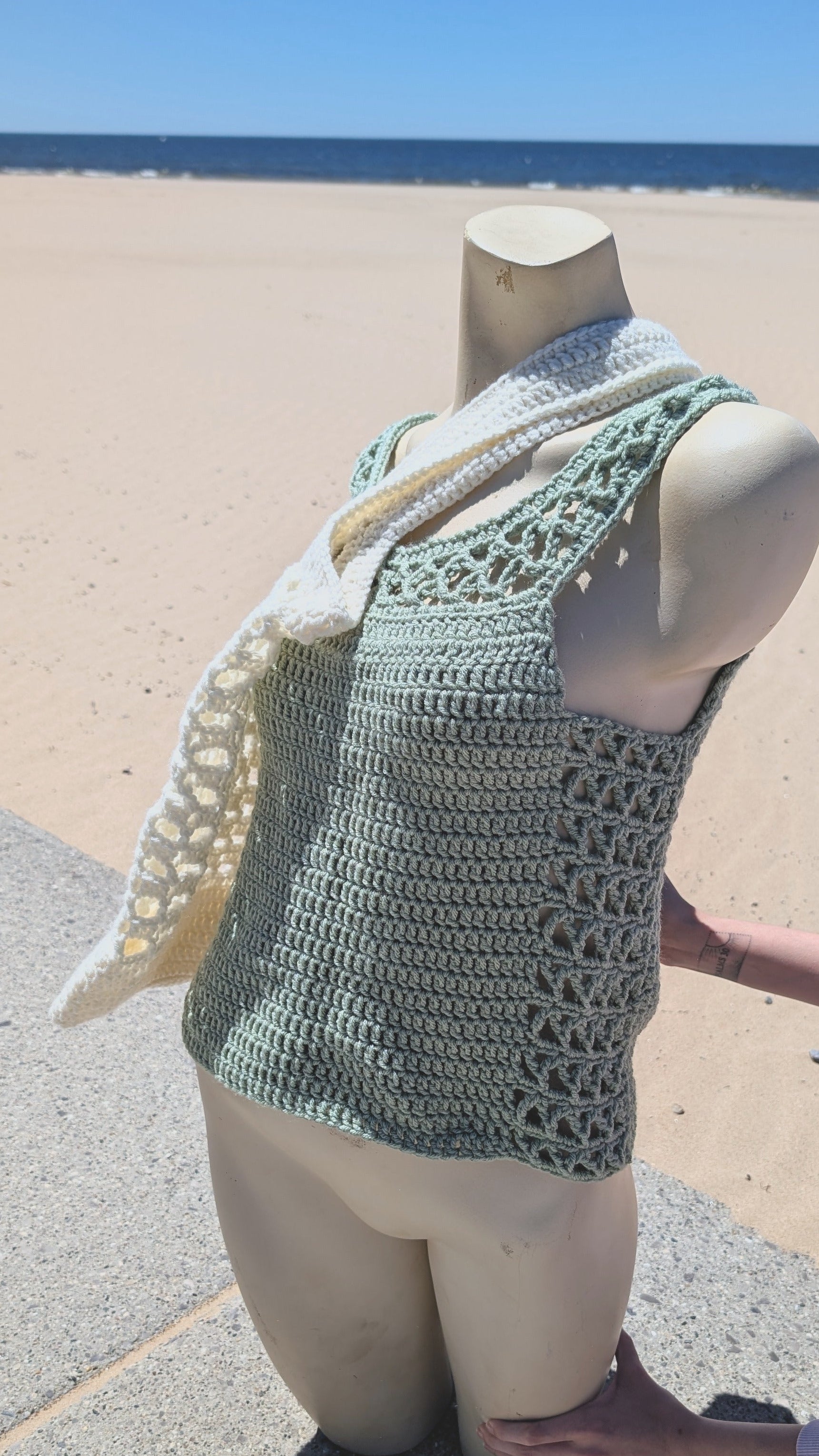 Mannequin wearing a bone color tot bag