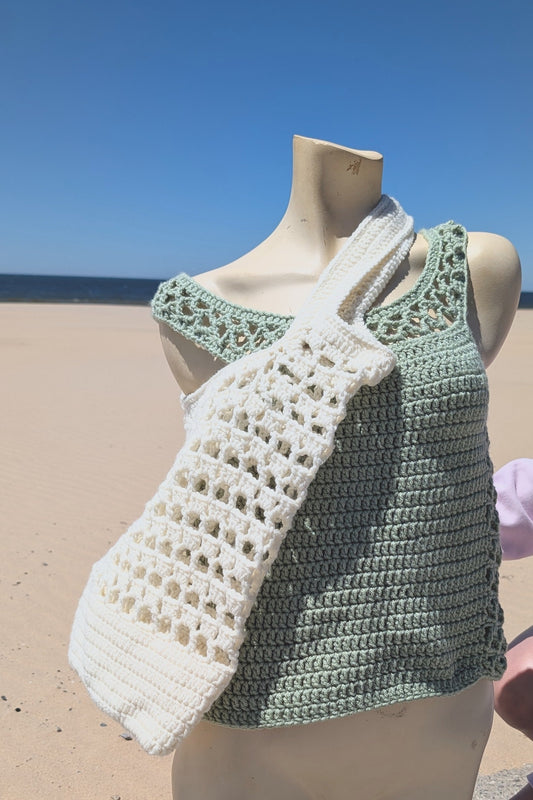 Mannequin wearing a crocheted lacey market bag or tote